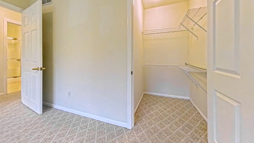 Carpeted apartment closet with white wire shelving at Emerald Pointe Senior Living in Greenville, Illinois.