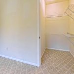 Carpeted apartment closet with white wire shelving at Emerald Pointe Senior Living in Greenville, Illinois.
