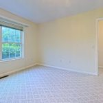 Bedroom with a large window at Emerald Pointe Senior Living in Greenville, Illinois.