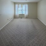 Living room with a window at Emerald Pointe Senior Living in Greenville, Illinois.