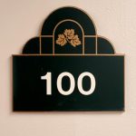 Apartment 100 sign on an interior wall at Emerald Pointe Senior Living in Greenville, Illinois.